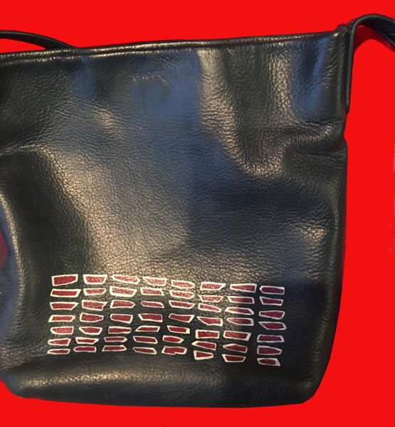 design added to blue purse